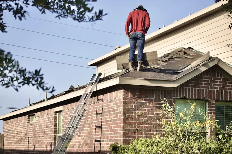 Professional roofer working on a residential roof in Upper Montclair